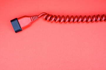 Top view  of the red plug on the red surface