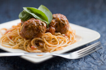 Close-up of spaghetti and meatballs with a fork