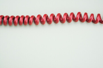 Top view of the red cable on the green surface