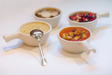 High angle view of four assorted soups