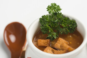Close-up of a cup of tomato soup with bread cubes