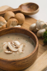 Close-up of a bowl of mushroom soup served with breads