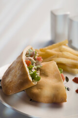 Stuffed pita sandwiches served with French fries