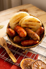 Arepa and sausage ​​served in a basket (typical Colombian food)