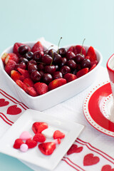 High angle view of a heart shaped bowl filled with assorted berries