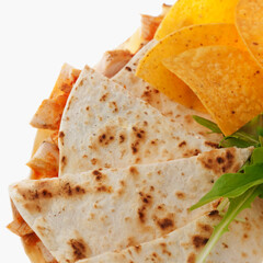 Close-up of quesadilla slices and nachos
