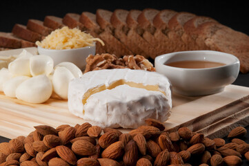 High angle view of assorted cheeses served with bread