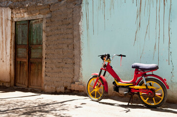 Fototapeta na wymiar Moped parked against wall, La Rioja Province, Argentina