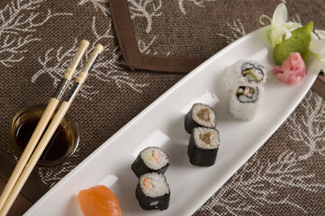 Close-up of various sushis in a plate with bowl of soy sauce