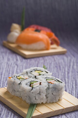 Close-up of uramaki and nigiri sushi on cutting boards