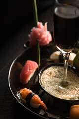 Close-up of sushi with a glass of wine in a plate