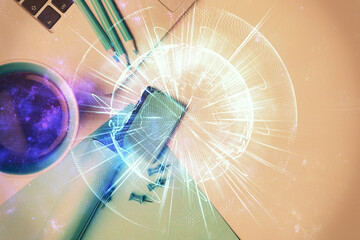 Business theme hologram drawings over computer on the desktop background. Top view. Multi exposure....