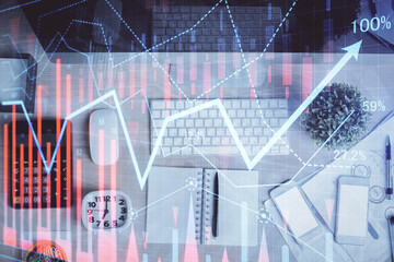 Double exposure of forex graph drawing over desktop background with computer. Concept of financial analysis. Top view.