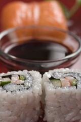 Close-up of sushi with a bowl of soy sauce