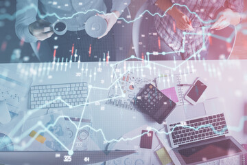Double exposure of man and woman working together and financial chart hologram drawing. market analysis concept. Computer background. Top View.