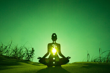 yoga position silhouette in contrasting sun, Heart chakra
