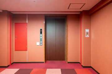Front of close elevator at vintage color style hotel