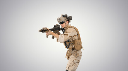 Soldier aiming with an assault rifle on gradient background.