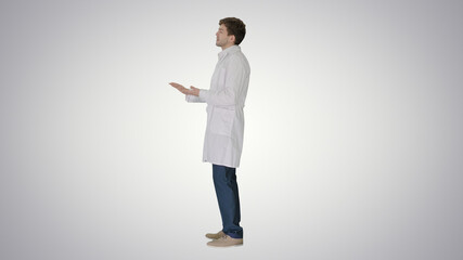 Doctor wearing white coat explaining something on gradient backg