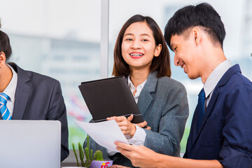 Young asian business woman and the business teams in the workplace in the office.