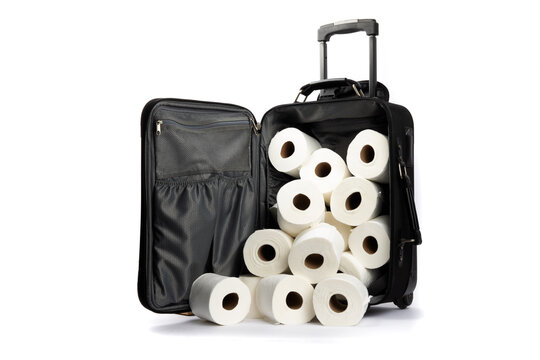 an open suitcase with rolls of hoarded toilet paper falling out isolated on white