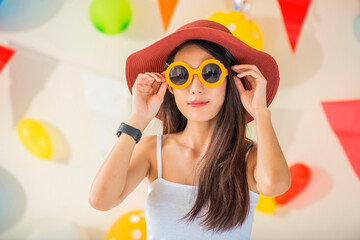 Beautiful happy woman at celebration party with confetti falling everywhere on her. Birthday or New Year eve celebrating concept