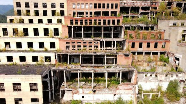 View from above. The camera flies past the abandoned plant of the Khrustalnensky mining and processing plant in the village of Khrustalny, Primorsky Territory. Abandoned tin mining plant