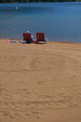 Beach chairs on lake beach at midday chilling out