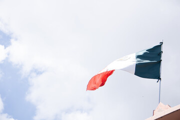 flag of mexico waved with the sky in the background