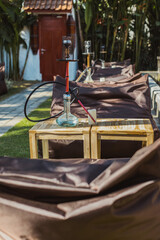 Shisha bar with sitting bag. Lounge place. hookah in interior. summer time. hookahs on the tables High quality photo