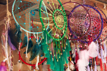 Fototapeta na wymiar Handcrafted multi-colored dreamcatchers are posted for sale in the market.