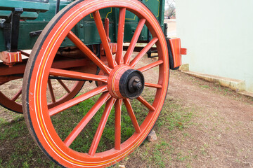 old red wheel on ancient historical ox wagon closeup in Pilgrims Rest, South Africa
