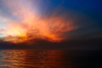 Naklejka na ściany i meble Sea sunset. Smoke wildfires sweeping across the sky.