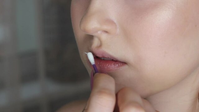 Make-up artist paints model's lips