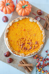 slice of pumpkin pie on plate with pumpkins