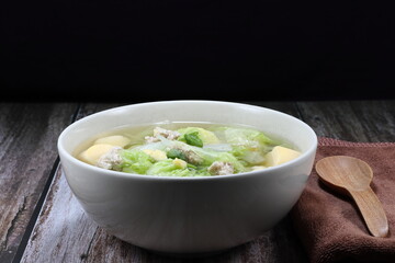 Clear soup of sliced Chinese cabbage with cutting egg tofu and minced pork meat in the bowl. Famous hot and soft soup in Asia restaurant. 