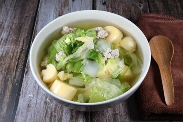 Clear soup of sliced Chinese cabbage with cutting egg tofu and minced pork meat in the bowl. Famous hot and soft soup in Asia restaurant. 