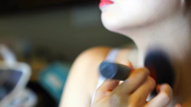 woman applying make up