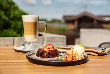 Chocolate fondant (cupcake) with strawberries and ice cream