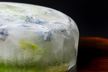 Ice cube and strawberry isolated on a white background