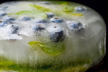 Ice cube and strawberry isolated on a white background