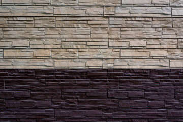the texture of decorative bricks in the form of masonry dark purple and light beige; the border of light and dark