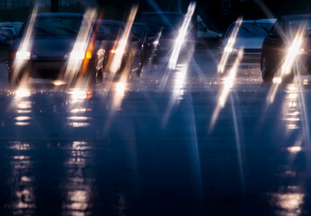 blurred traffic viewed through a car windscreen. driving in the rain