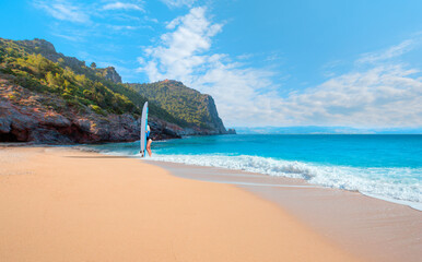 Beautiful surfer woman on the beach at sunny day - Cleopatra beach, Alanya