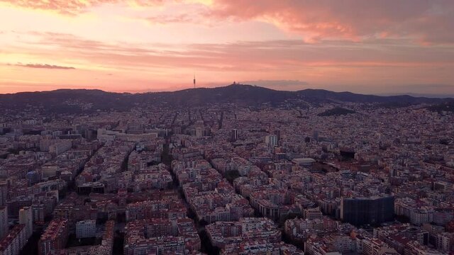 Aerial drone view on pink sunset over Barcelona City blocks, Spain