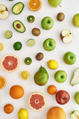 Top view of composition of various colorful fresh summer fruits scattered isolated over white background