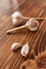 Close up of whole garlic and clove on the wooden table