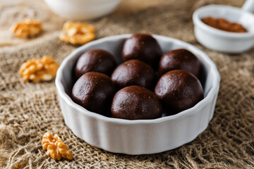 Dates walnuts chocolate raw balls in a plate