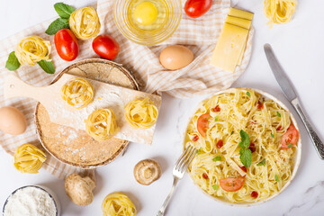 fresh pasta and pasta machine on kitchen table