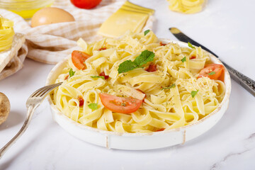 fresh pasta and pasta machine on kitchen table